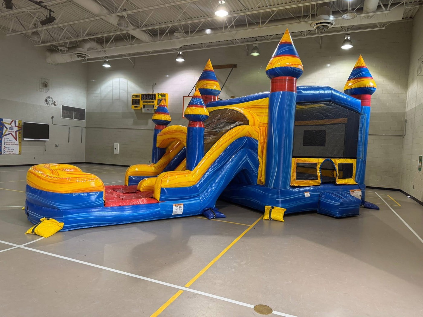 Blue yellow and red castle bounce house with slide