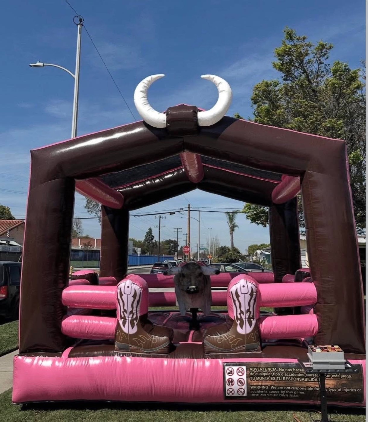 Pink and brown mechanical bull arena with oversized horn topper and cowboy boot bumpers