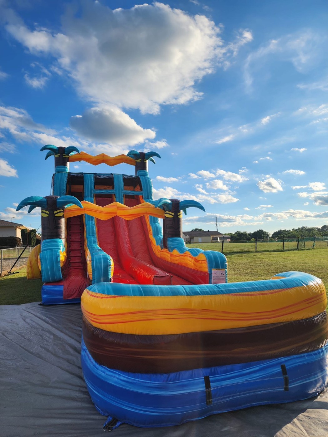 Orange red and teal fire tiki themed double lane water slide